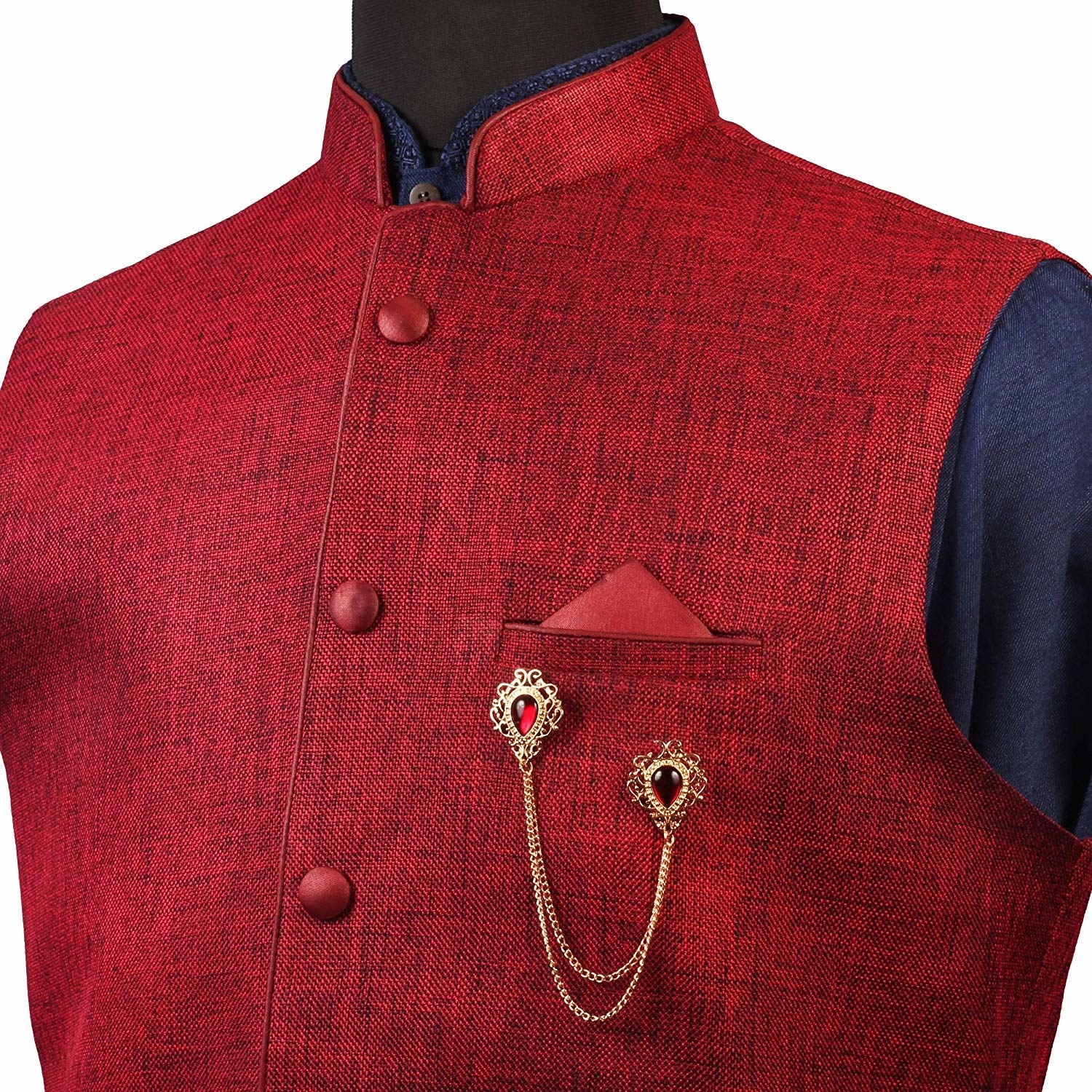 The brooch being showcased on a red Nehru jacket.