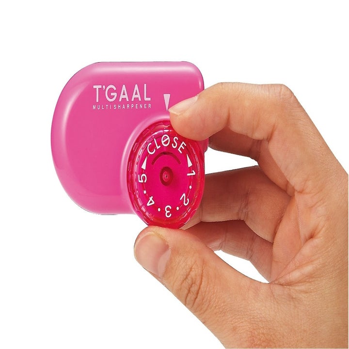 A small round pencil sharpener with a dial on the side