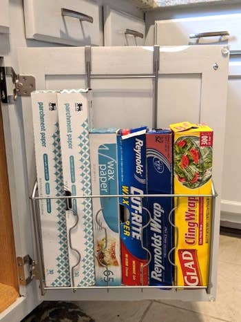 reviewer photo of plastic wrap, tinfoil, and similar boxes inside the organizer 