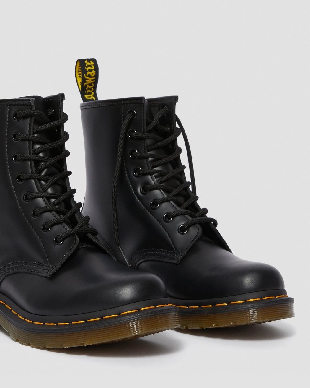 The black lace-up boots with yellow stitching around the sole