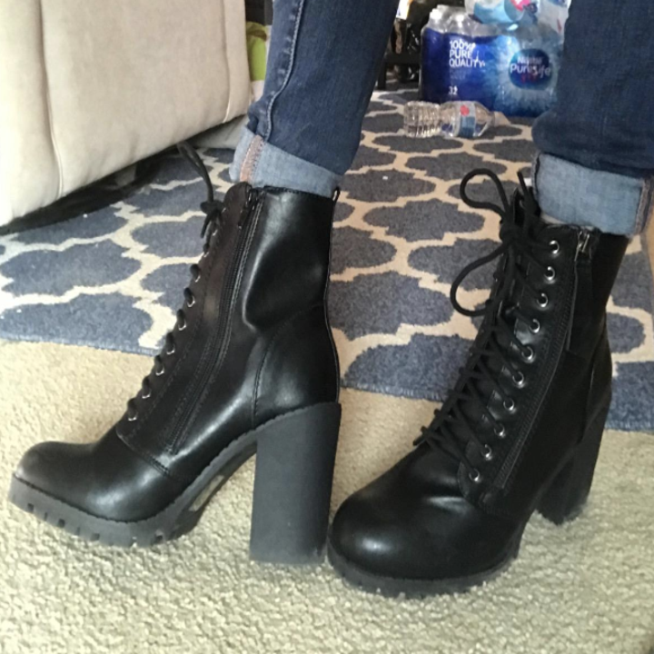 a reviewer wearing the boots in black