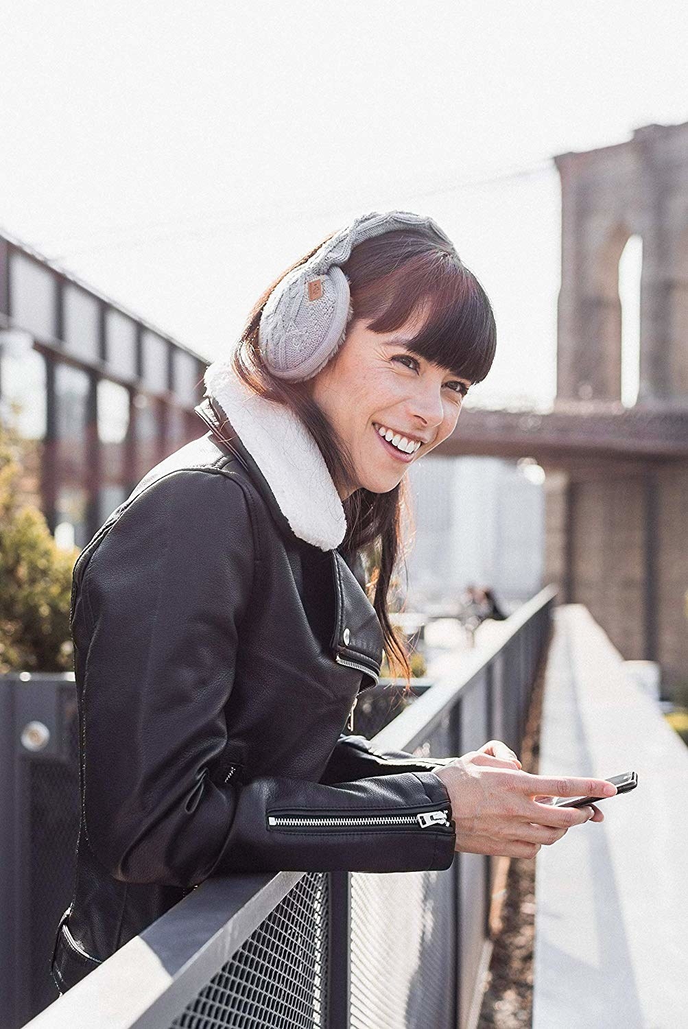 model wearing the gray bluetooth earmuffs