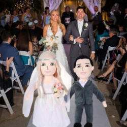 A married couple and their matching dolls in wedding attire 