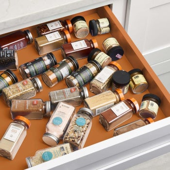 open spice drawer with jars thrown in haphazardly