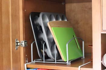 horizontal rack with muffin tins and cutting boards slotted into it