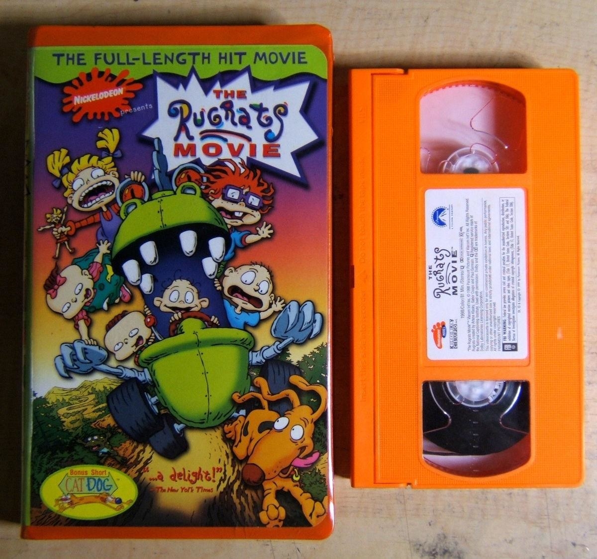 An orange VHS tape of the Rugrats movie next to its clamshell case