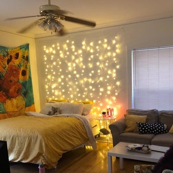 reviewer's twinkle lights above their bed 