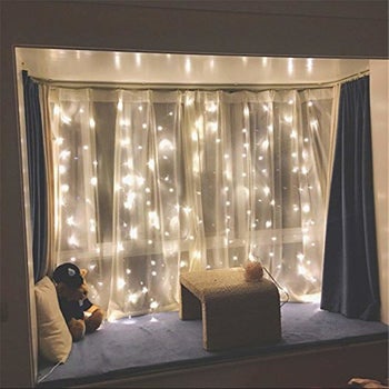  twinkle lights hanging in a window 