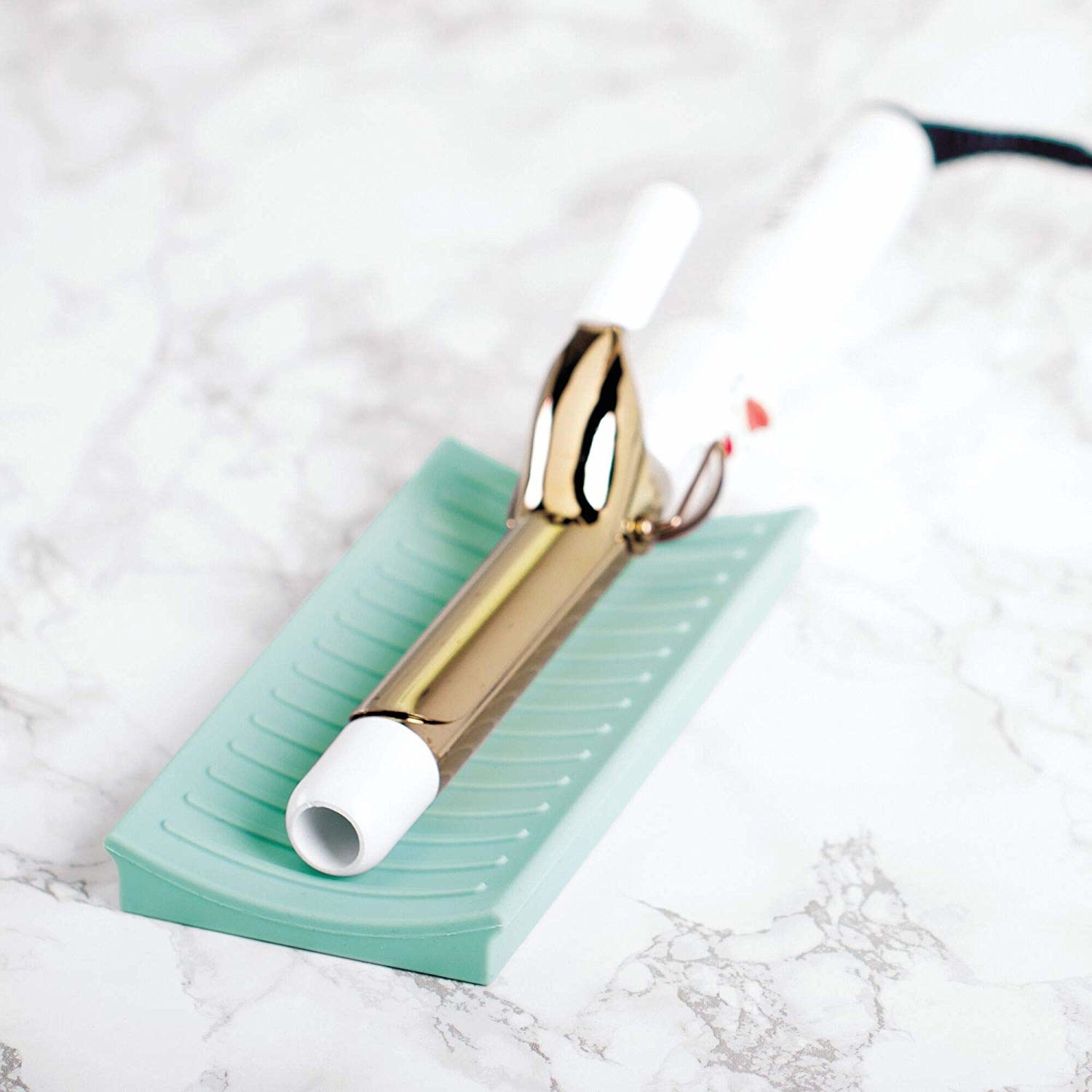 A curling iron on the mat