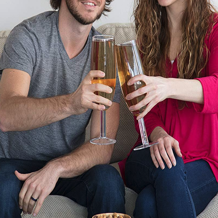 two people cheersing with two big glasses