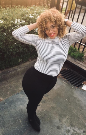 a reviewer in the long sleeve top in white with thin vertical black stripes