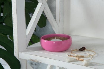 the pink dish on a shelf