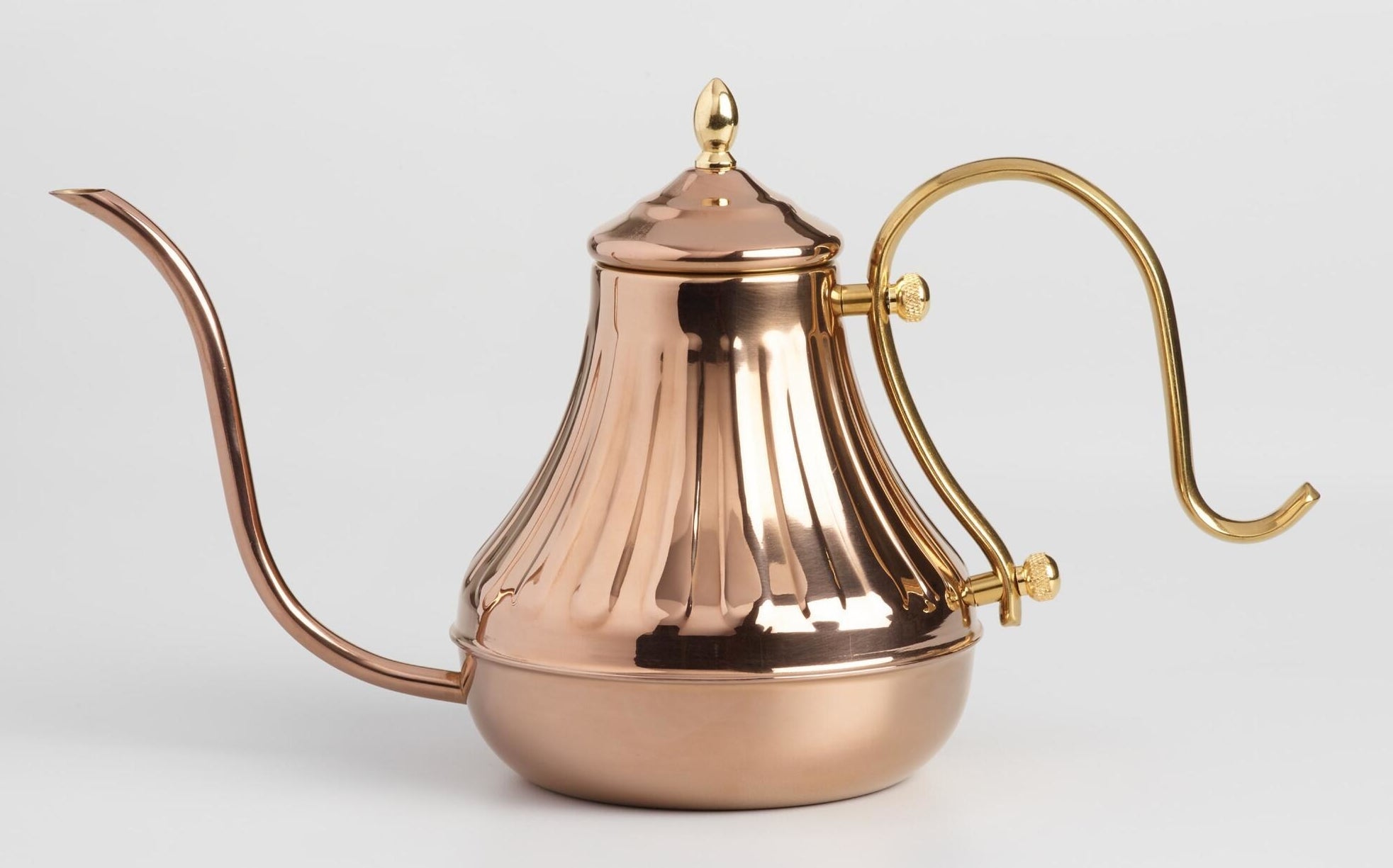 The copper kettle with a swoopy spout and handle in gold