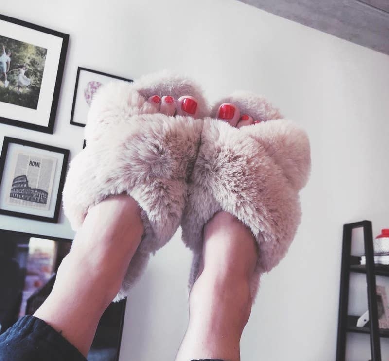 reviewer image of the criss-cross fuzzy open-toe slippers in light pink