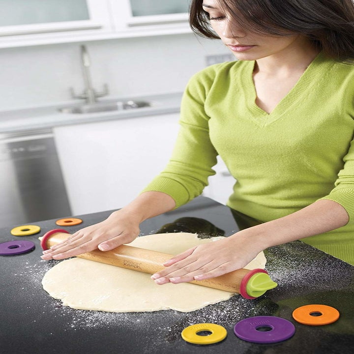 a model using the rolling pin the roll out dough