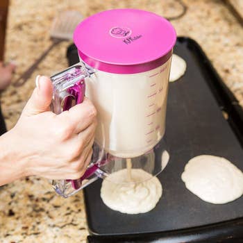 a model using the dispenser to make perfectly circular pancakes