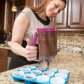 a model using the dispenser to put batter into baking cups