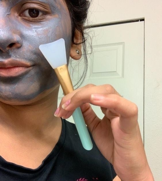 Reviewer using the silicone brush to apply face mask