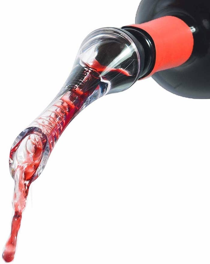Long, thin, clear aerator with wine pouring through it