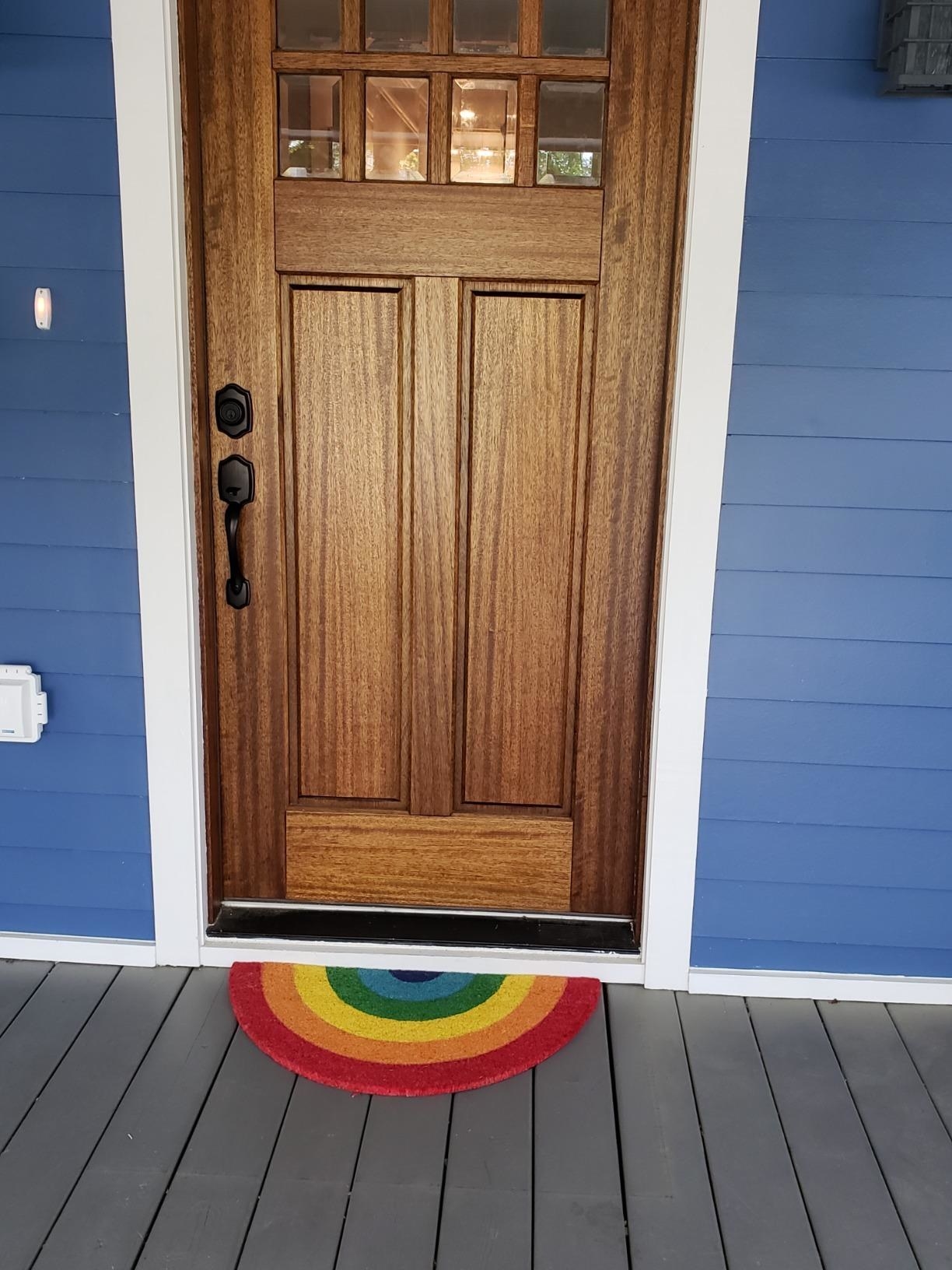 rainbow doormat outside home 