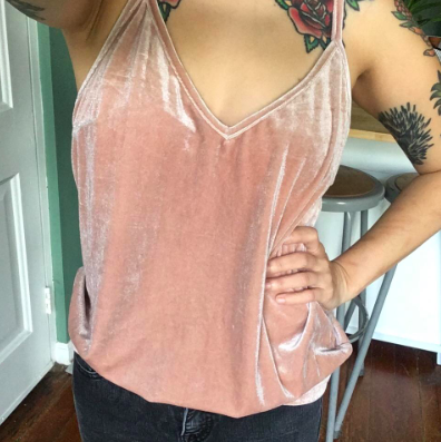 petite reviewer wearing a light pink velvet camisole with jeans
