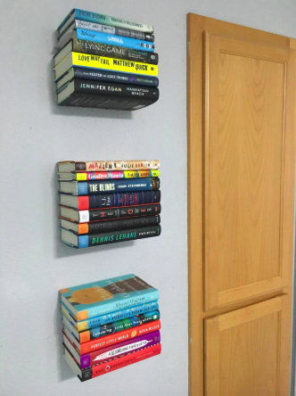 reviewer pic of three of the shelves installed with colorful books in place