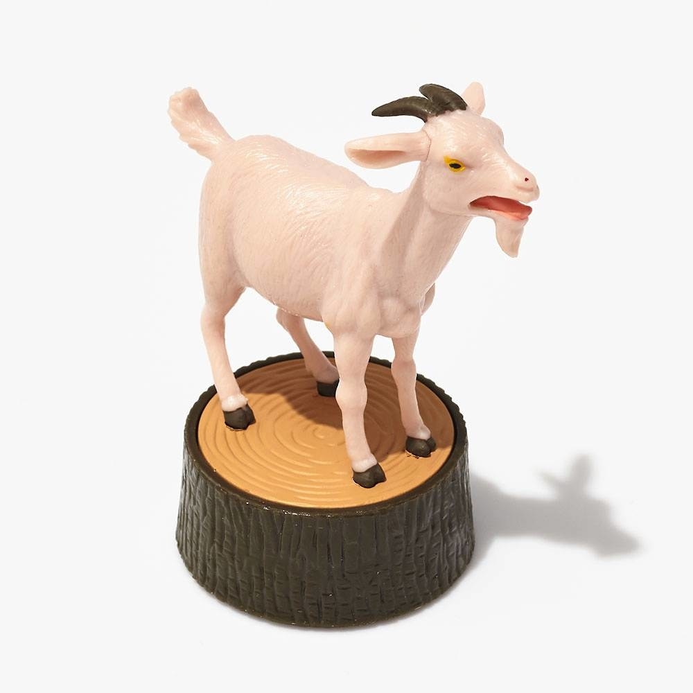 plastic goat on stump 