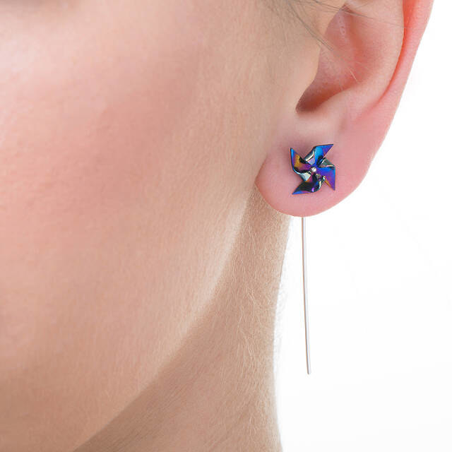pinwheel earring with long stick behind earlobe 