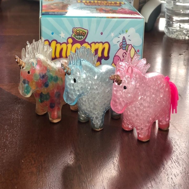 three clear unicorns with colorful beads inside 