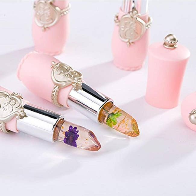 clear lipstick with flower and gold flecks in it 