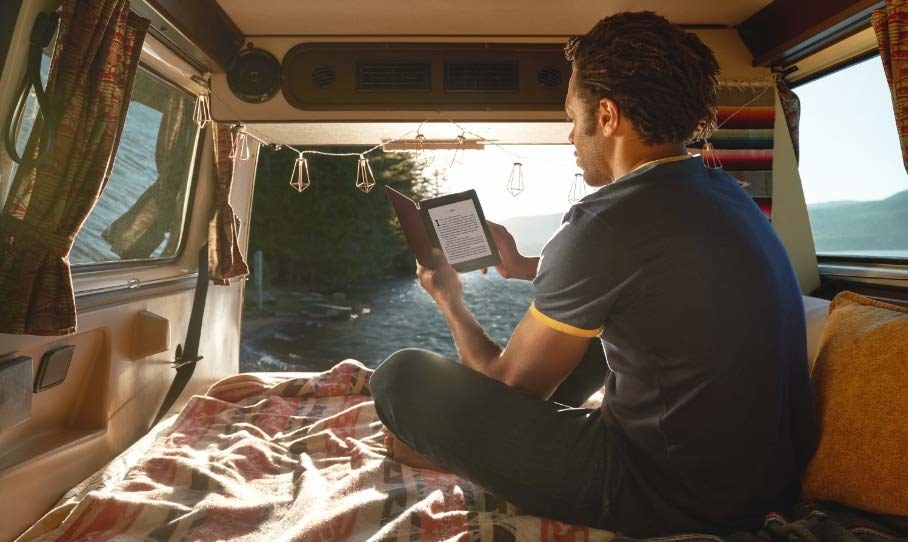 person reading in the back of a van