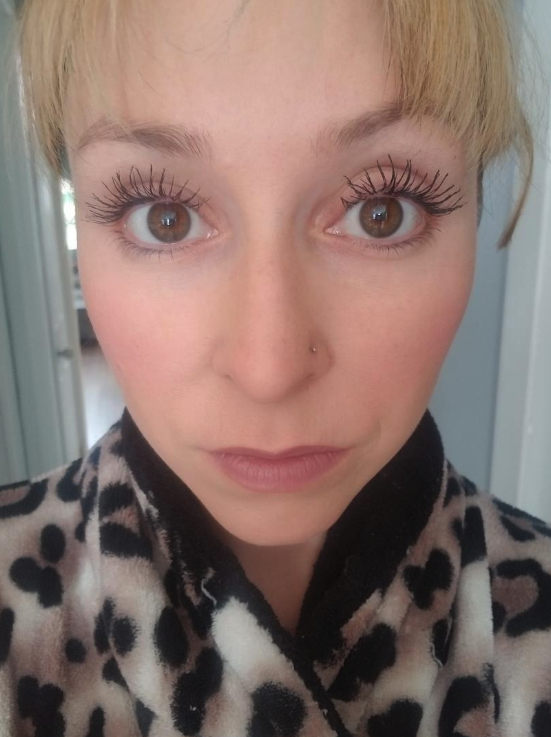 A woman showing her long eyelashes with the mascara on.