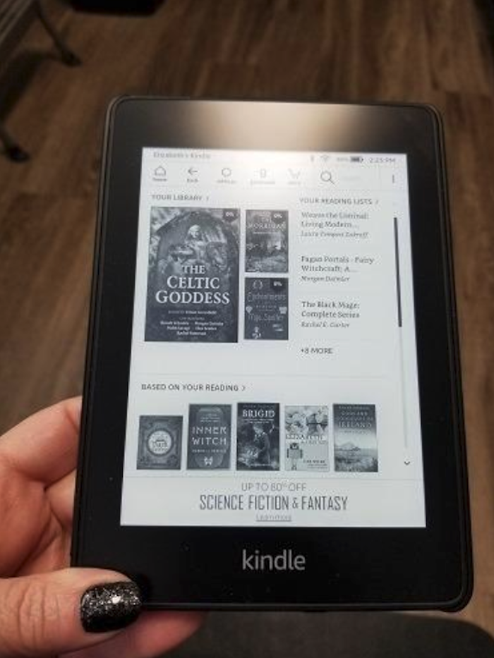 reviewer&#x27;s hand holding the kindle