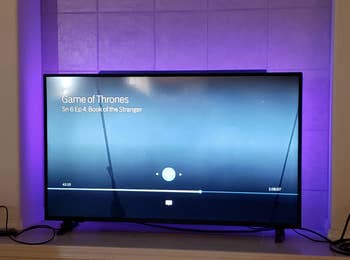 a reviewer's tv with glowing purple lights behind it