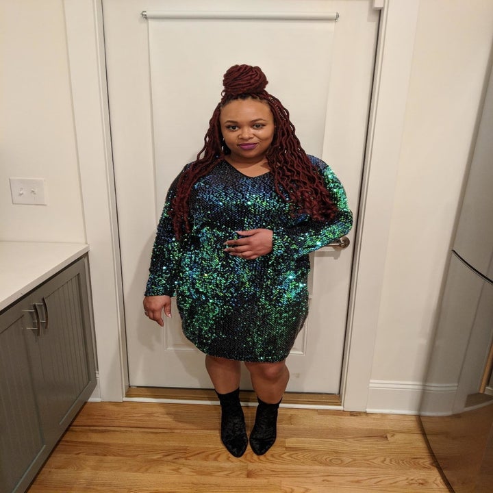 Reviewer wearing the long-sleeved sequin knee-length bodycon dress in blue and green