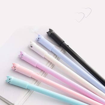six of the pens in mint, peach, pink, white, lilac, and black