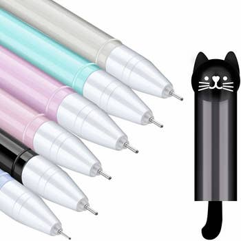 close up on the pens' fine tips and the cap with a cat head on top and tail at the bottom