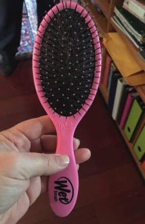 a reviewer's pink hair brush