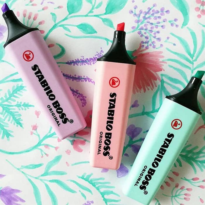 Three highlighters on a handdrawn floral background