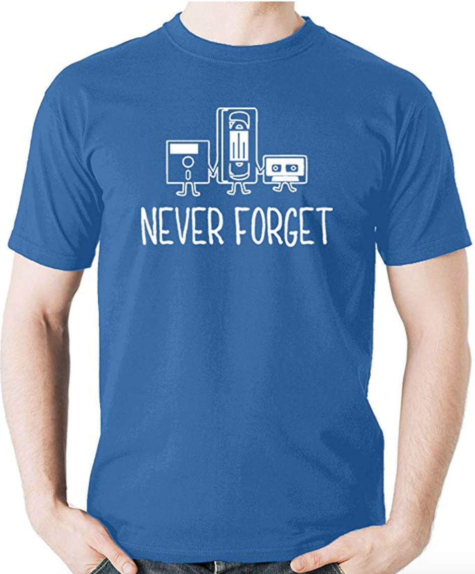 A person wearing a cotton t-shirt with old gaming controllers on it and a slogan never forget