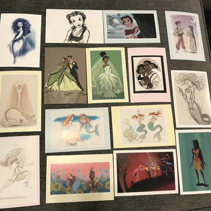a reviewer showing an array of the princess postcards