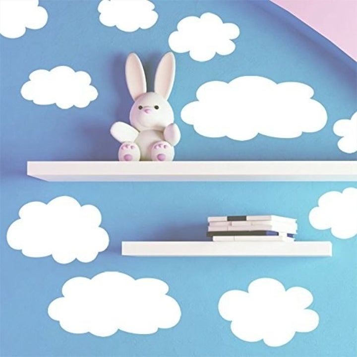 a blue wall with white cloud decals