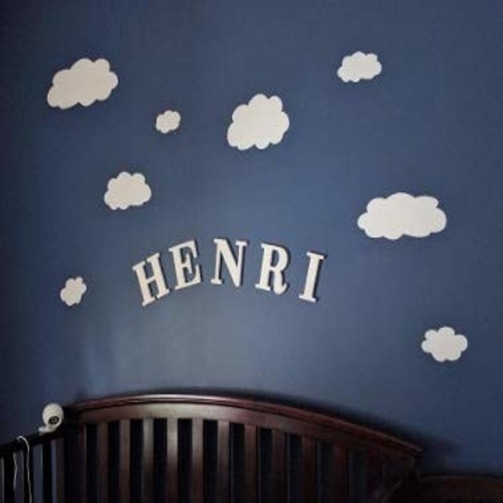 a dark blue wall with white clouds on it