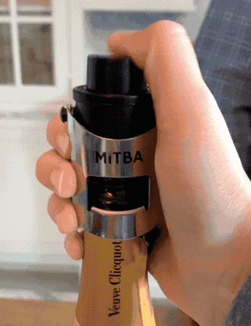 Gif of a hand pressing the vacuum seal button of the stopper