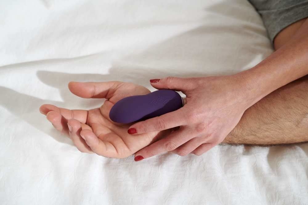 Two people holding small vibrator 