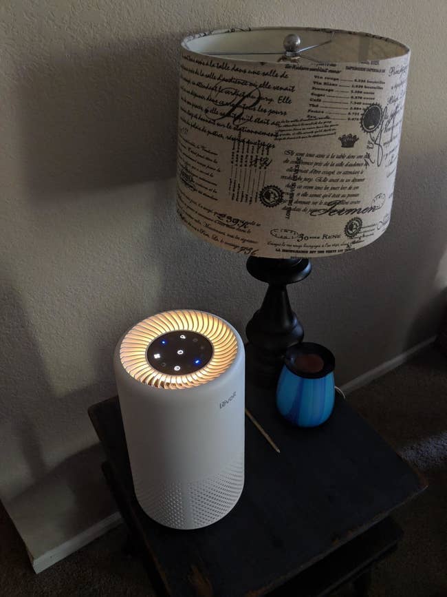 The small white air purifier on a table