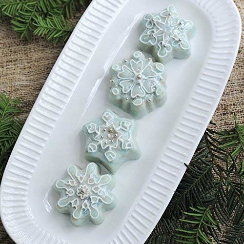 plate with three snowflake shaped cakes on it made with mold