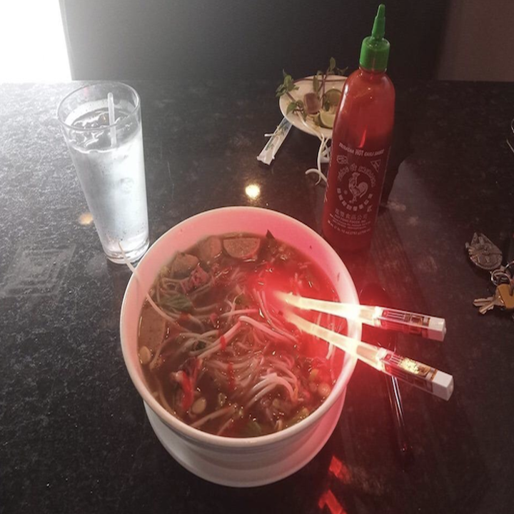 lightsaber chopstick with red light in a bowl of food