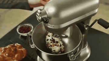 A KitchenAid mixer mixing dough