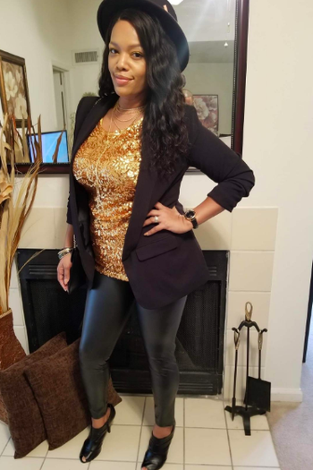 A reviewer wearing the black leggings with a sequined top and blazer